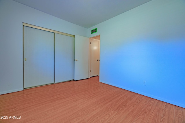 1726 W Claremont St, Phoenix, AZ 85015 - unfurnished bedroom featuring wood finished floors, baseboards, and a closet