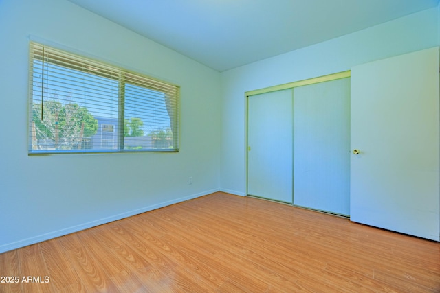 1726 W Claremont St, Phoenix, AZ 85015 - unfurnished bedroom featuring wood finished floors, a closet, and baseboards