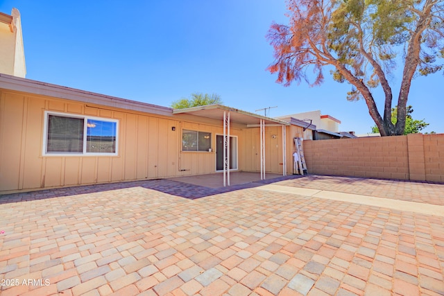 1726 W Claremont St, Phoenix, AZ 85015 - back of property with fence, a patio area, and board and batten siding