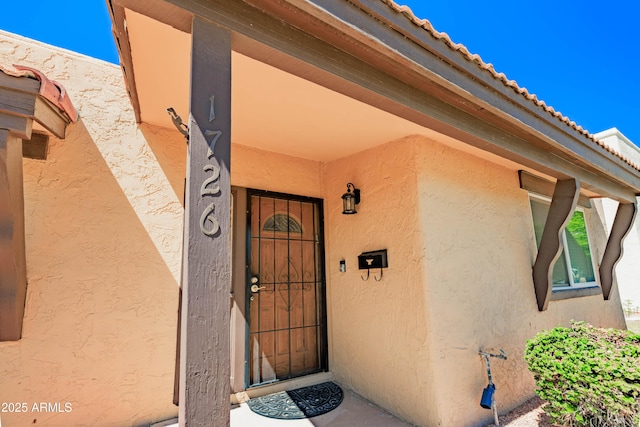 1726 W Claremont St, Phoenix, AZ 85015 - doorway to property with stucco siding and a tiled roof
