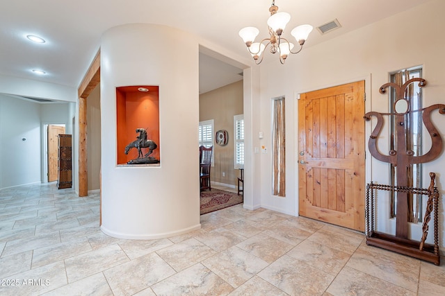 foyer entrance featuring a chandelier