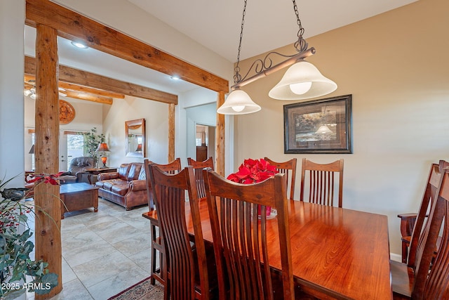 dining area featuring beam ceiling