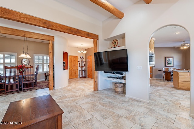 living room with beam ceiling and ceiling fan with notable chandelier