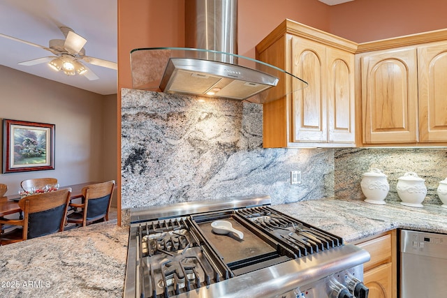 kitchen with light brown cabinets, wall chimney exhaust hood, backsplash, and light stone countertops