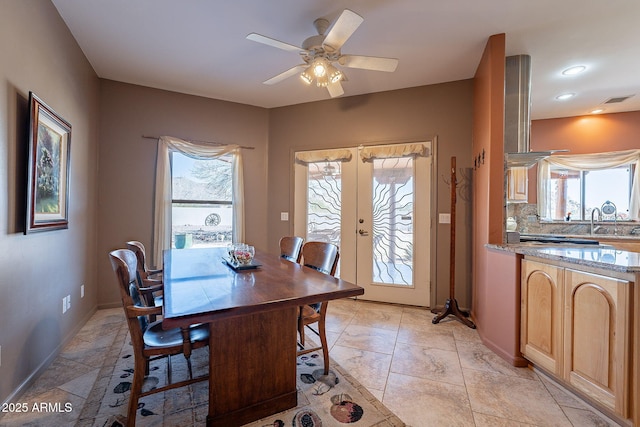 dining room featuring ceiling fan, french doors, and sink