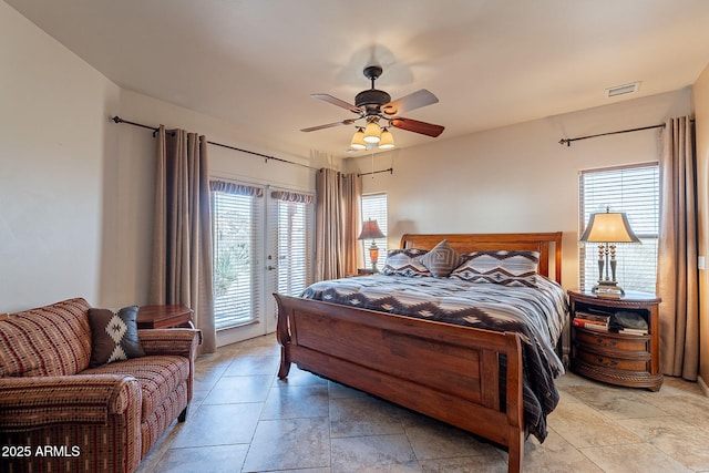 bedroom featuring access to outside, ceiling fan, and multiple windows