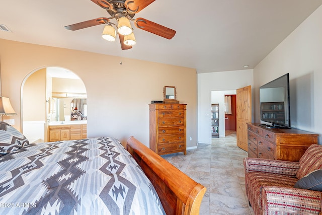 bedroom featuring ceiling fan, light tile patterned floors, and connected bathroom