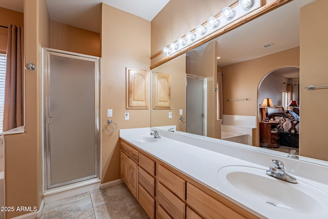 bathroom with vanity and shower with separate bathtub