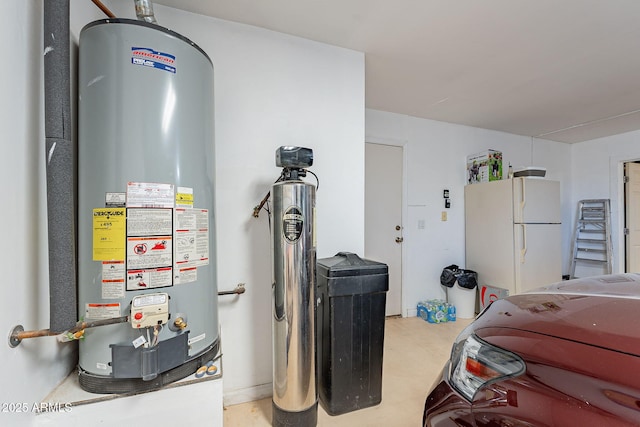 garage featuring white fridge and gas water heater