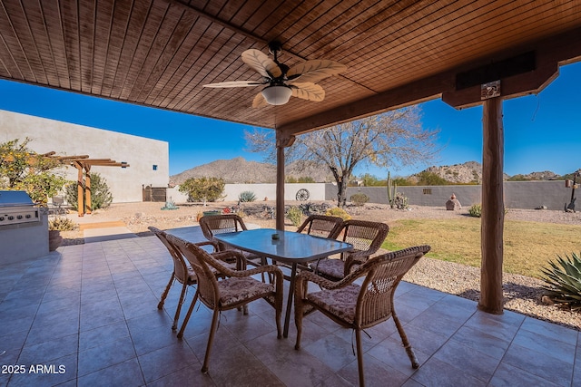 view of patio featuring a mountain view, grilling area, and ceiling fan