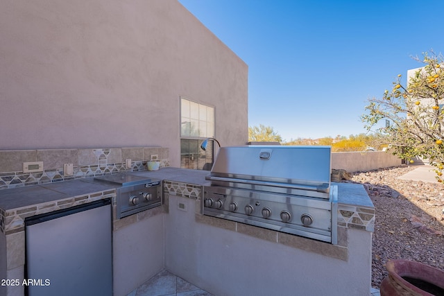 view of patio with a grill and an outdoor kitchen