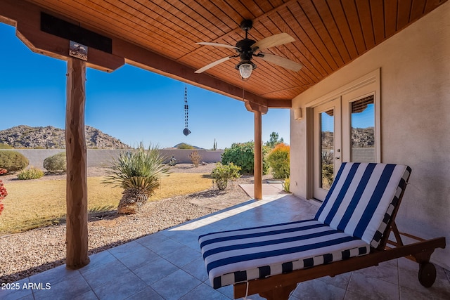 view of patio / terrace with ceiling fan and a mountain view