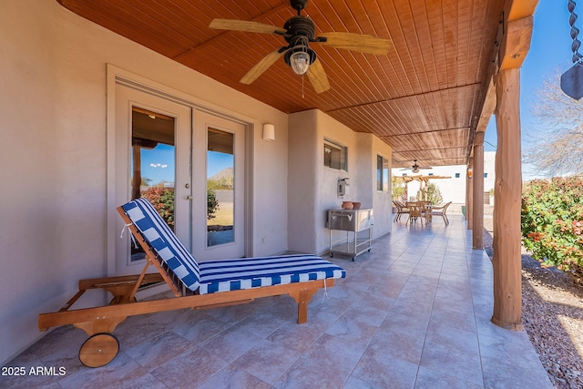 view of patio / terrace featuring ceiling fan and french doors