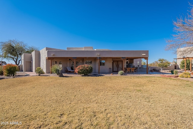 back of house with a patio area and a yard