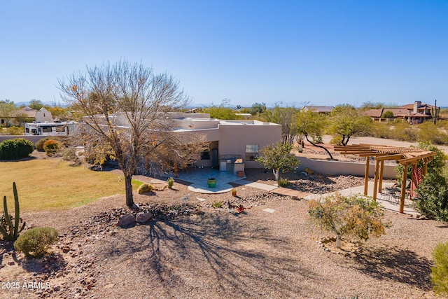 rear view of house with a yard, a pergola, and a patio