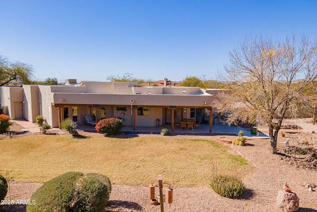 rear view of property featuring a patio