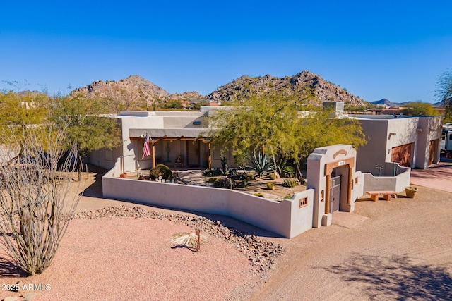 pueblo revival-style home featuring a mountain view