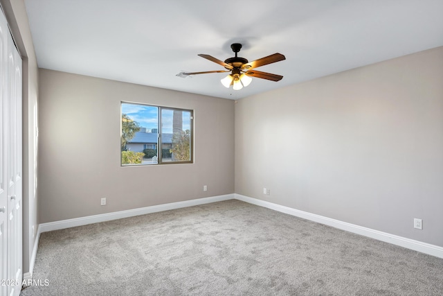 empty room with ceiling fan and carpet flooring