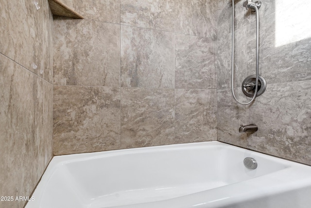 bathroom featuring tiled shower / bath