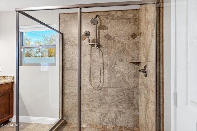 bathroom with vanity and tiled shower