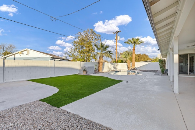 view of yard with a fenced in pool and a patio