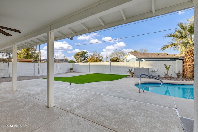 view of pool featuring a patio and a yard