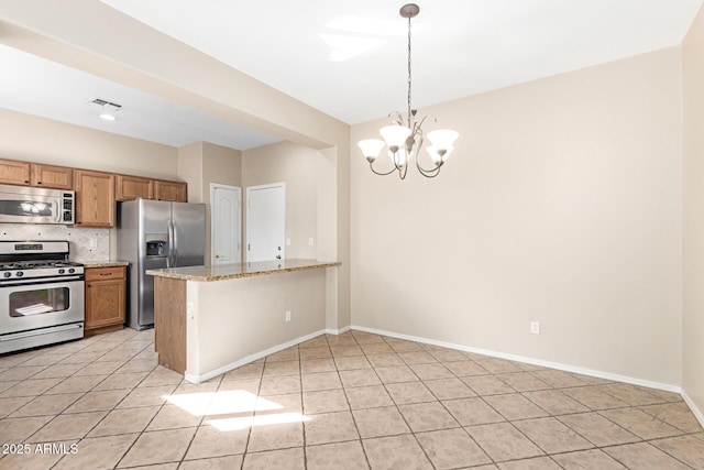 kitchen with decorative light fixtures, visible vents, appliances with stainless steel finishes, light stone countertops, and a peninsula