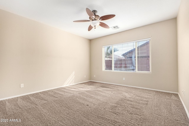 empty room featuring ceiling fan, carpet, visible vents, and baseboards