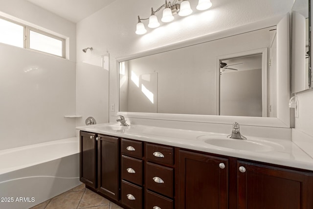 bathroom with double vanity, shower / washtub combination, a sink, and tile patterned floors