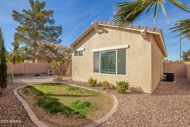 view of home's exterior featuring a fenced backyard, a patio, cooling unit, and stucco siding