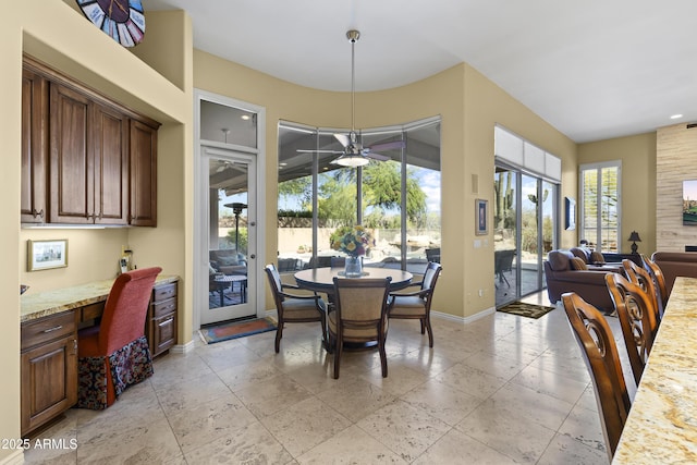 dining space featuring baseboards, ceiling fan, stone tile floors, and recessed lighting