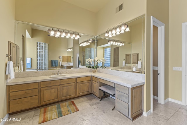 full bath with vanity, tile patterned floors, and baseboards