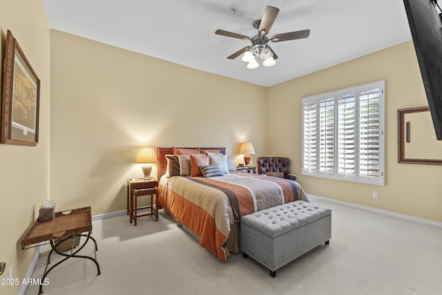 bedroom with light colored carpet, baseboards, and ceiling fan