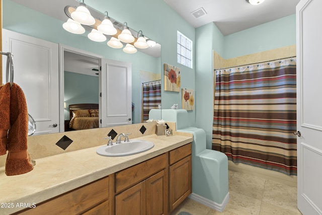bathroom featuring connected bathroom, vanity, and tile patterned flooring