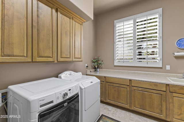 washroom with cabinet space and washing machine and clothes dryer