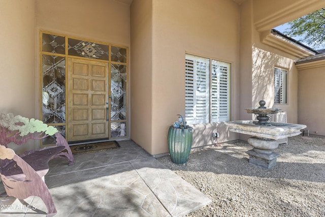 doorway to property with stucco siding