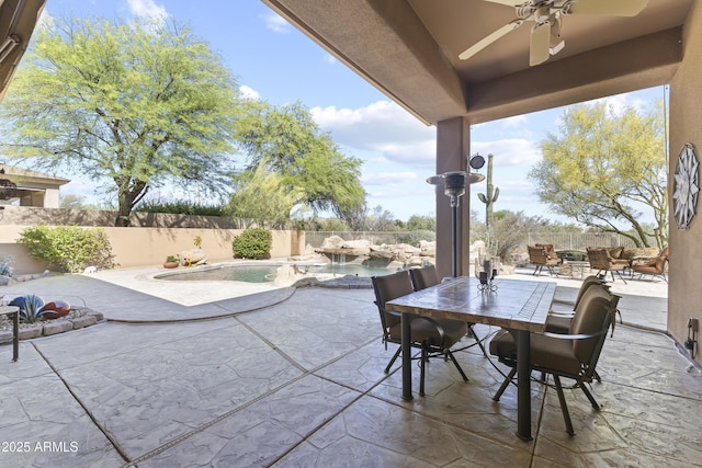 fenced backyard featuring a ceiling fan, a patio area, and outdoor dining area