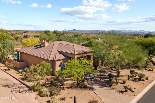 aerial view of property and surrounding area with a mountain backdrop