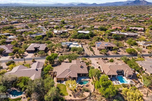 aerial perspective of suburban area with a pool area and mountains