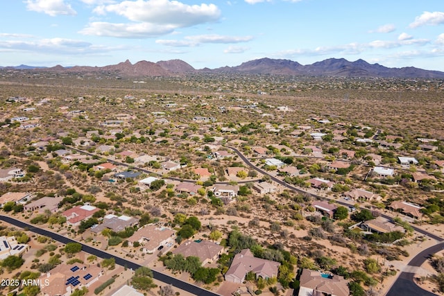 aerial view of property and surrounding area featuring mountains and nearby suburban area