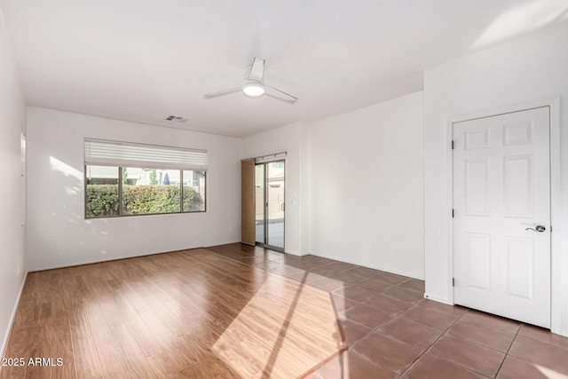 unfurnished room featuring dark hardwood / wood-style flooring and ceiling fan