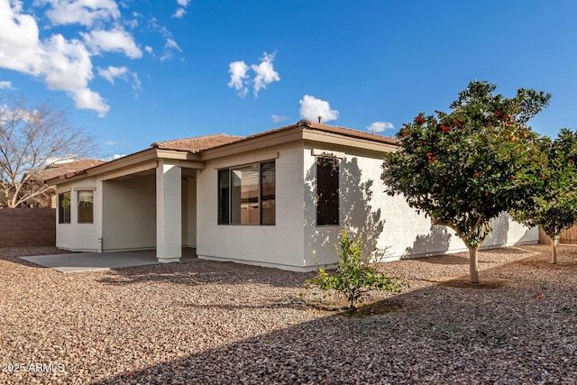 view of side of home with a patio area