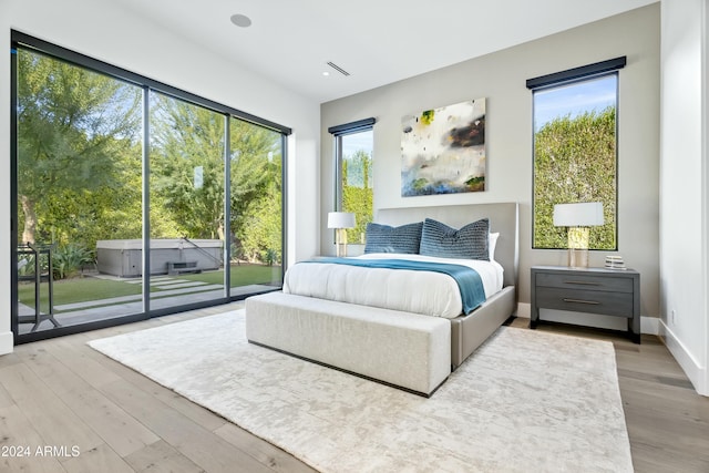 6862 E Joshua Tree Ln, Paradise Valley, AZ 85253 - bedroom with access to exterior, wood finished floors, and baseboards