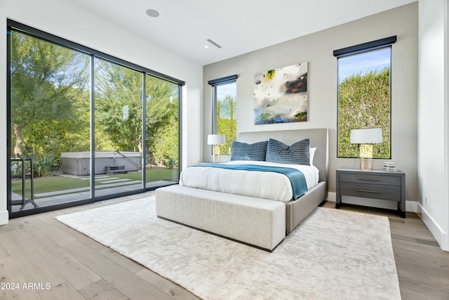 bedroom featuring access to outside and light hardwood / wood-style flooring