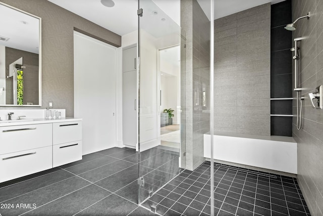 bathroom featuring tiled shower, vanity, and tile patterned floors