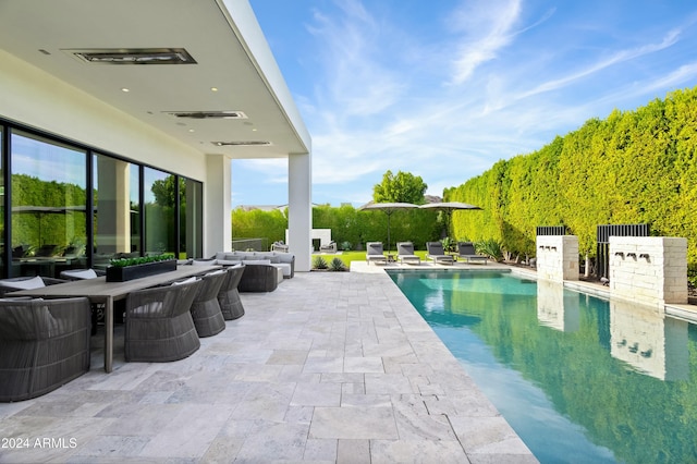 6862 E Joshua Tree Ln, Paradise Valley, AZ 85253 - outdoor pool featuring a patio area, an outdoor living space, and a ceiling fan