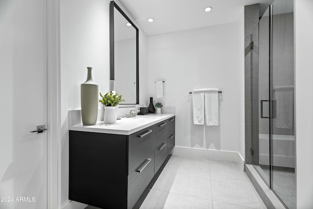 bathroom featuring vanity, tile patterned floors, and a shower with door