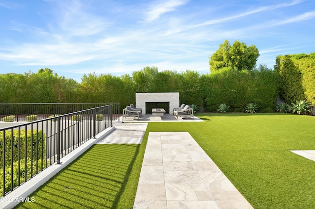 6862 E Joshua Tree Ln, Paradise Valley, AZ 85253 - view of yard with a patio and an outdoor fireplace