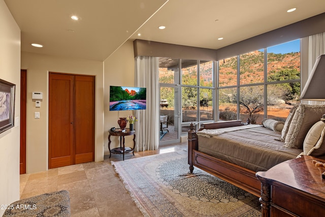 bedroom with multiple windows and recessed lighting