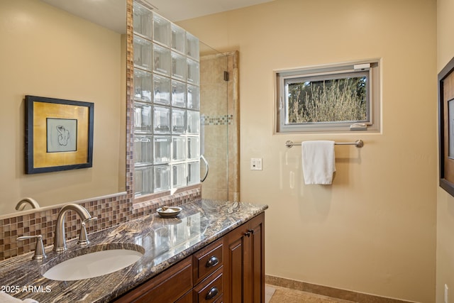 full bath with baseboards, vanity, and decorative backsplash